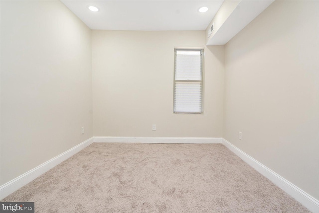 unfurnished room with light carpet