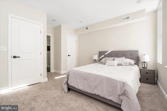 bedroom featuring light carpet