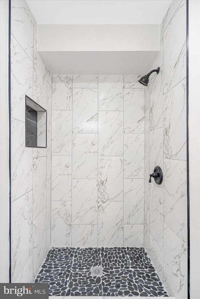 bathroom with tiled shower