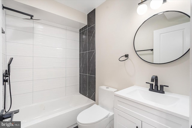 full bathroom featuring toilet, tiled shower / bath combo, and vanity