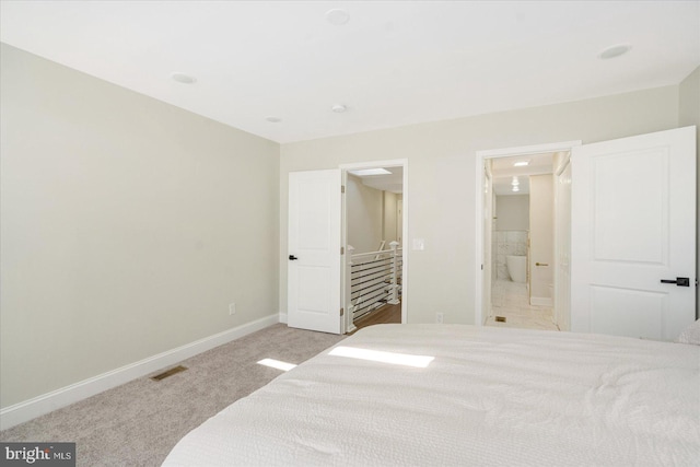 carpeted bedroom featuring ensuite bathroom