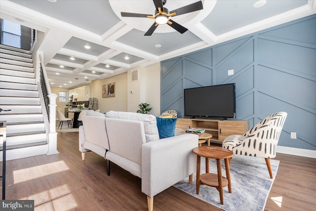 living room with coffered ceiling, hardwood / wood-style flooring, ceiling fan, and beamed ceiling