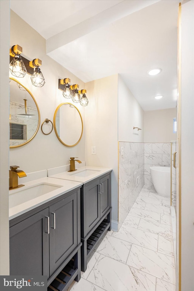 bathroom featuring a tub to relax in and vanity