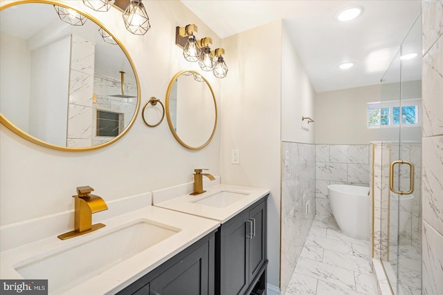 bathroom with tile walls, vanity, and independent shower and bath