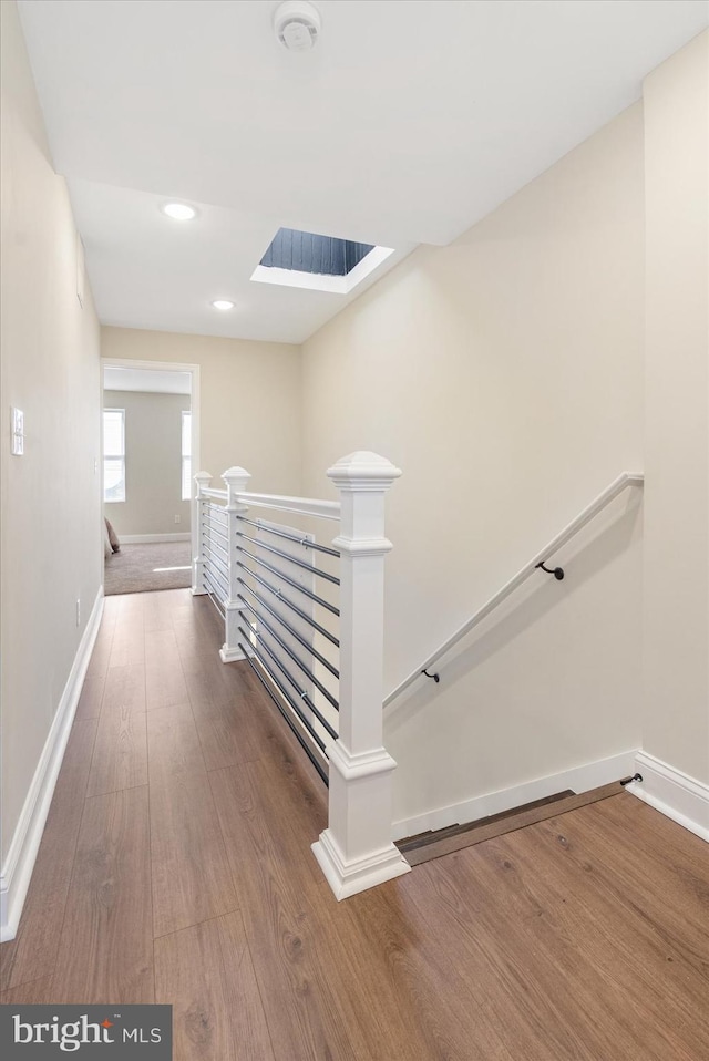 hall with wood-type flooring