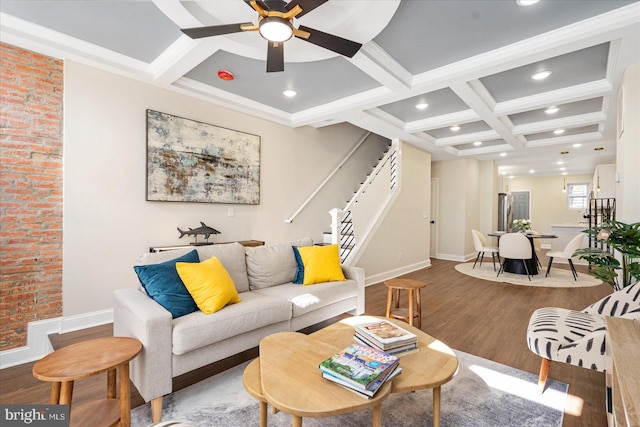 living room featuring hardwood / wood-style flooring, coffered ceiling, ornamental molding, beamed ceiling, and ceiling fan