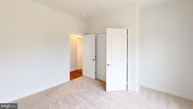 unfurnished bedroom featuring light colored carpet