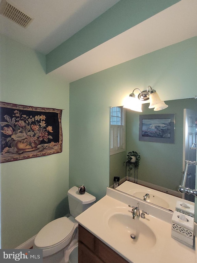 bathroom featuring vanity and toilet