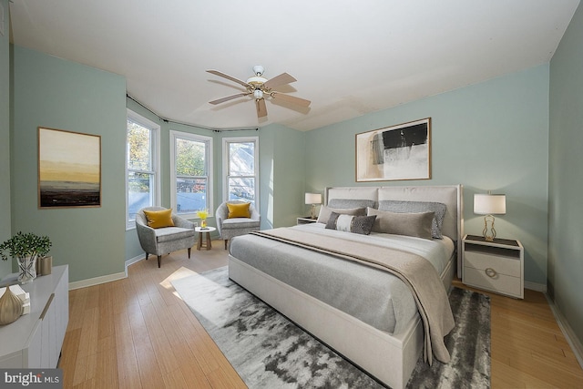 bedroom with ceiling fan and light hardwood / wood-style floors