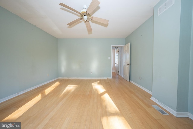 empty room with light wood-type flooring and ceiling fan