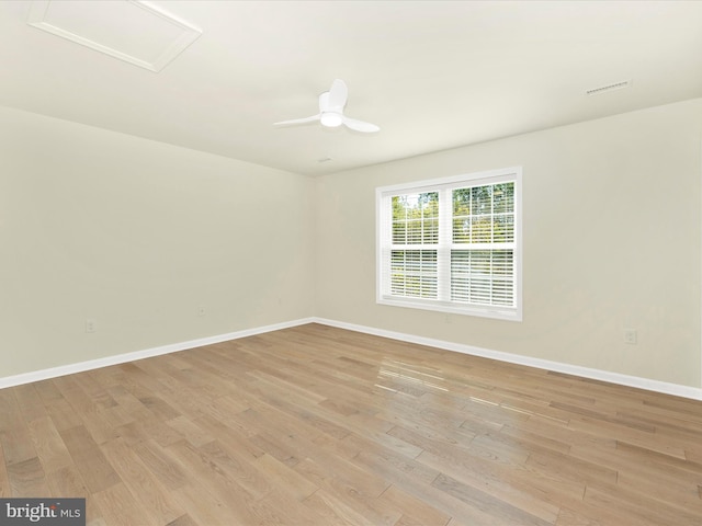 spare room with light wood-type flooring and ceiling fan