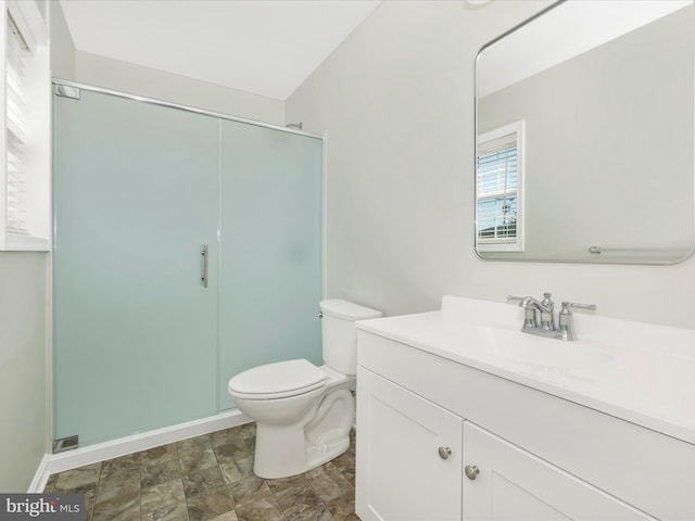 bathroom featuring vanity, toilet, and an enclosed shower