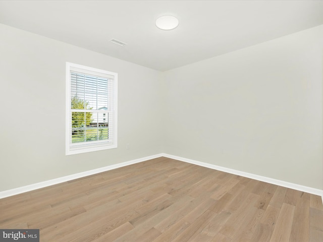 unfurnished room with light wood-type flooring