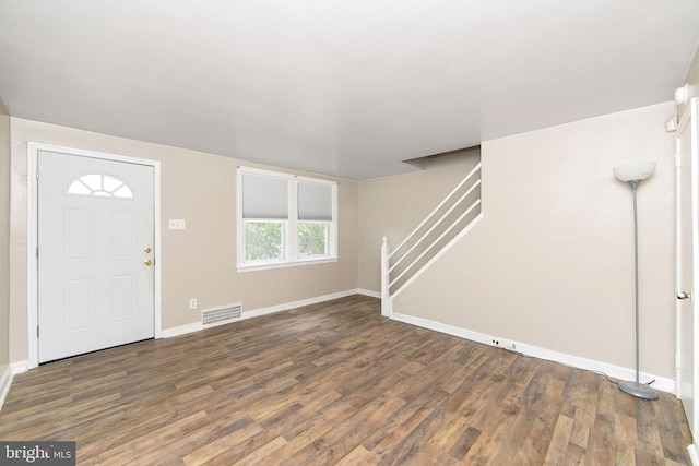 entryway featuring a healthy amount of sunlight and dark hardwood / wood-style flooring