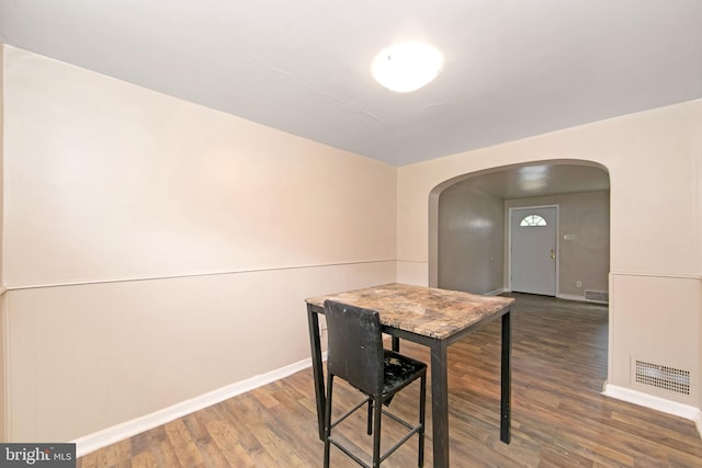 dining area featuring dark wood-type flooring