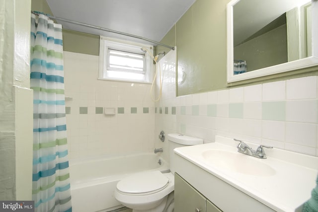 full bathroom with vanity, tasteful backsplash, shower / bath combo, tile walls, and toilet