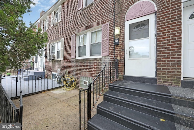 view of exterior entry with brick siding