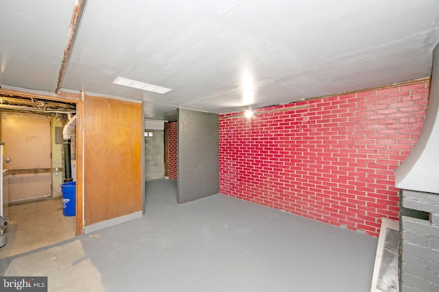 basement featuring brick wall