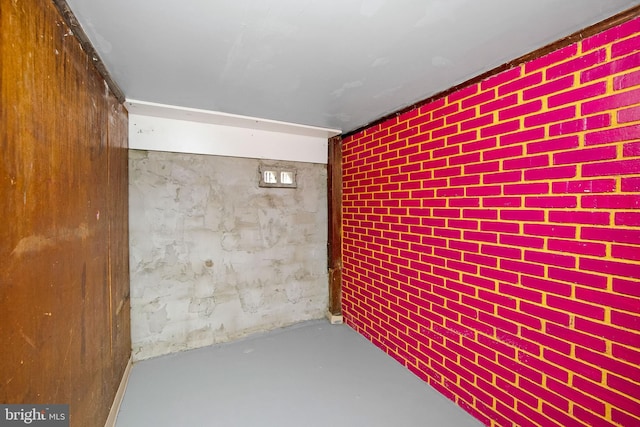 basement featuring brick wall