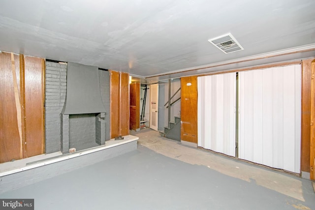 basement featuring a brick fireplace