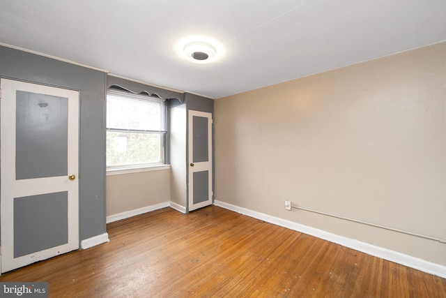 unfurnished bedroom with hardwood / wood-style flooring