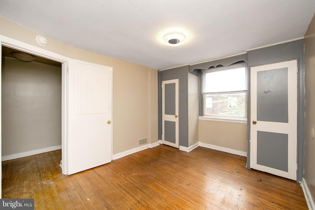 unfurnished bedroom with wood-type flooring