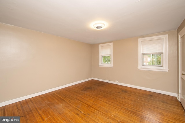 empty room with hardwood / wood-style flooring