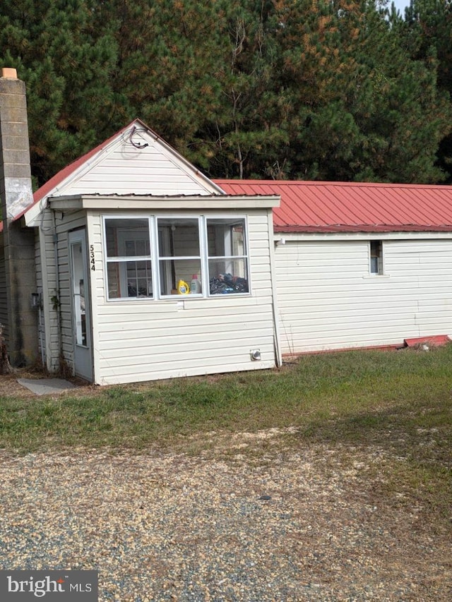 view of side of home featuring metal roof
