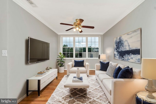 living room featuring crown molding, light hardwood / wood-style floors, and ceiling fan