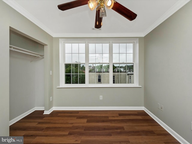 unfurnished bedroom with ornamental molding, dark hardwood / wood-style floors, a closet, and ceiling fan