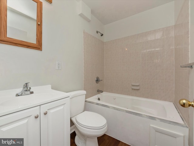 full bathroom featuring vanity, toilet, hardwood / wood-style flooring, and tiled shower / bath