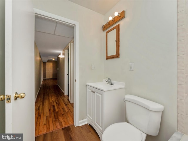 bathroom featuring vanity, wood-type flooring, and toilet