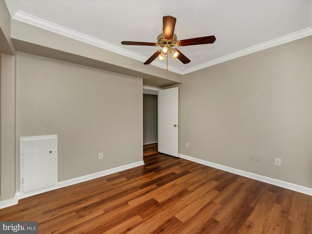 empty room featuring ceiling fan, ornamental molding, and dark hardwood / wood-style floors