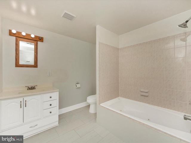 full bathroom featuring vanity, tiled shower / bath, toilet, and tile patterned floors