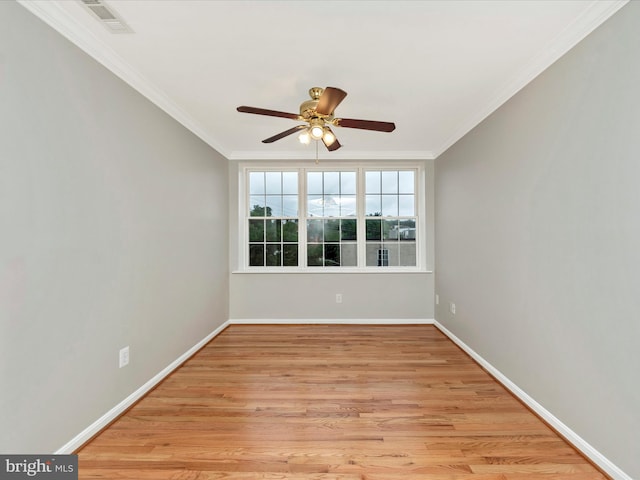 empty room with ornamental molding, light hardwood / wood-style flooring, and ceiling fan