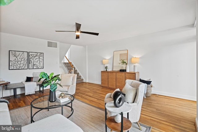 living room featuring ceiling fan and light hardwood / wood-style floors