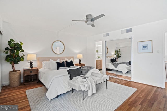 bedroom featuring ceiling fan, dark hardwood / wood-style flooring, and a closet