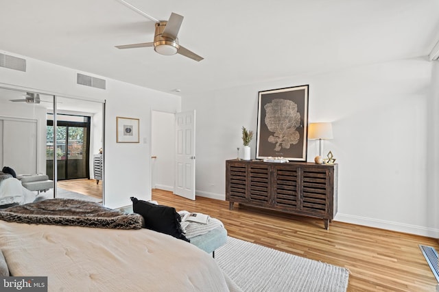 bedroom with ceiling fan, wood-type flooring, and a closet