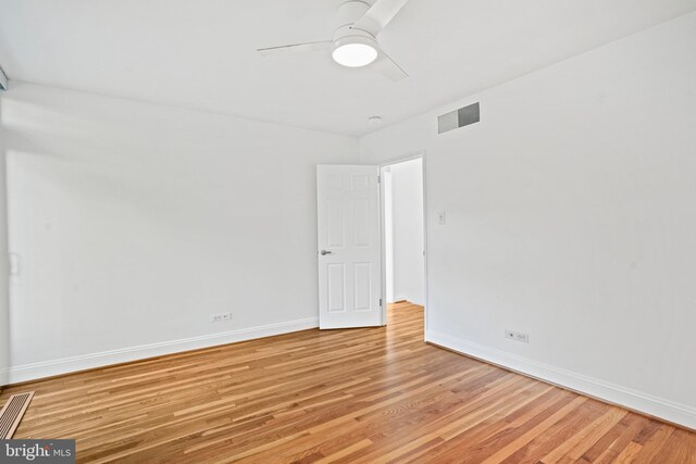 spare room featuring ceiling fan and hardwood / wood-style floors