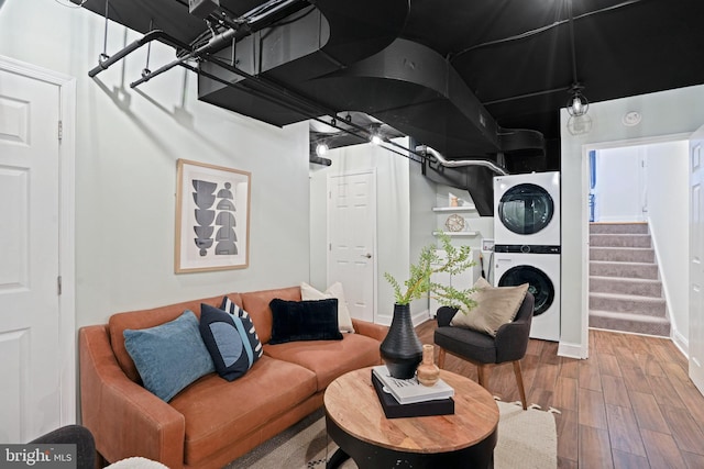 living room with hardwood / wood-style floors and stacked washer / dryer