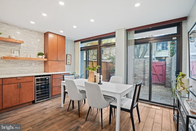 dining area with hardwood / wood-style floors, wine cooler, and expansive windows