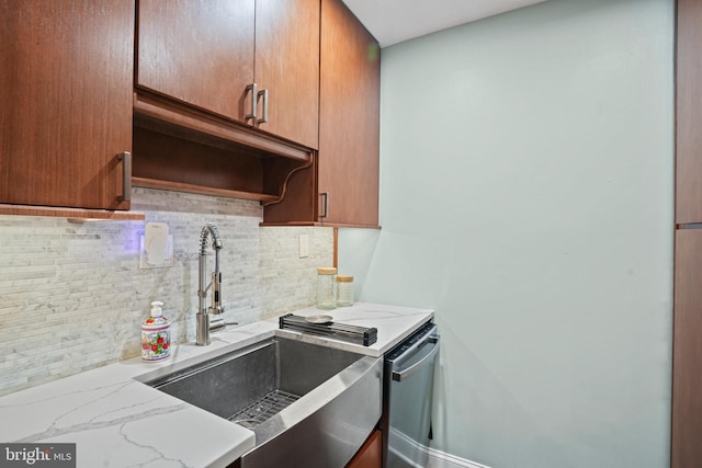 kitchen with dishwasher, light stone counters, sink, and tasteful backsplash