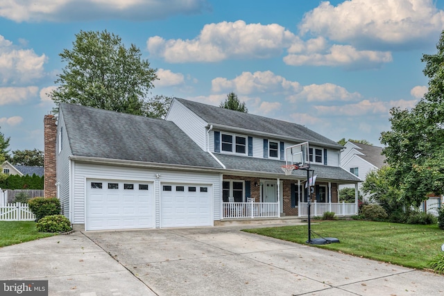 front facade featuring covered porch, a garage, and a front yard