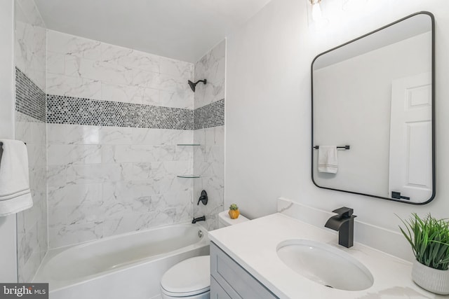 full bathroom featuring tiled shower / bath combo, vanity, and toilet