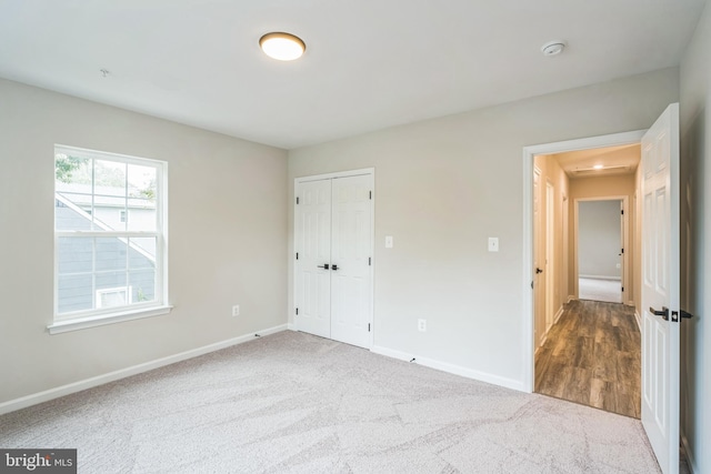 unfurnished bedroom featuring carpet floors and a closet