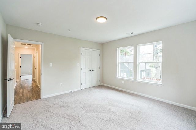 unfurnished bedroom with a closet and carpet