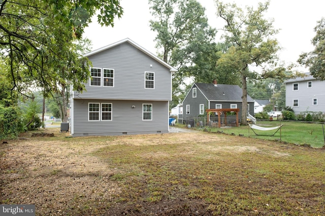 back of house with a lawn