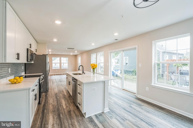 kitchen featuring white cabinets and a healthy amount of sunlight