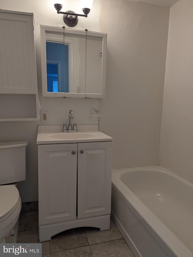 bathroom featuring tile patterned flooring, vanity, toilet, and a bath