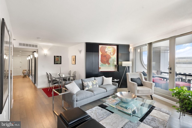 living room with light wood-type flooring and french doors